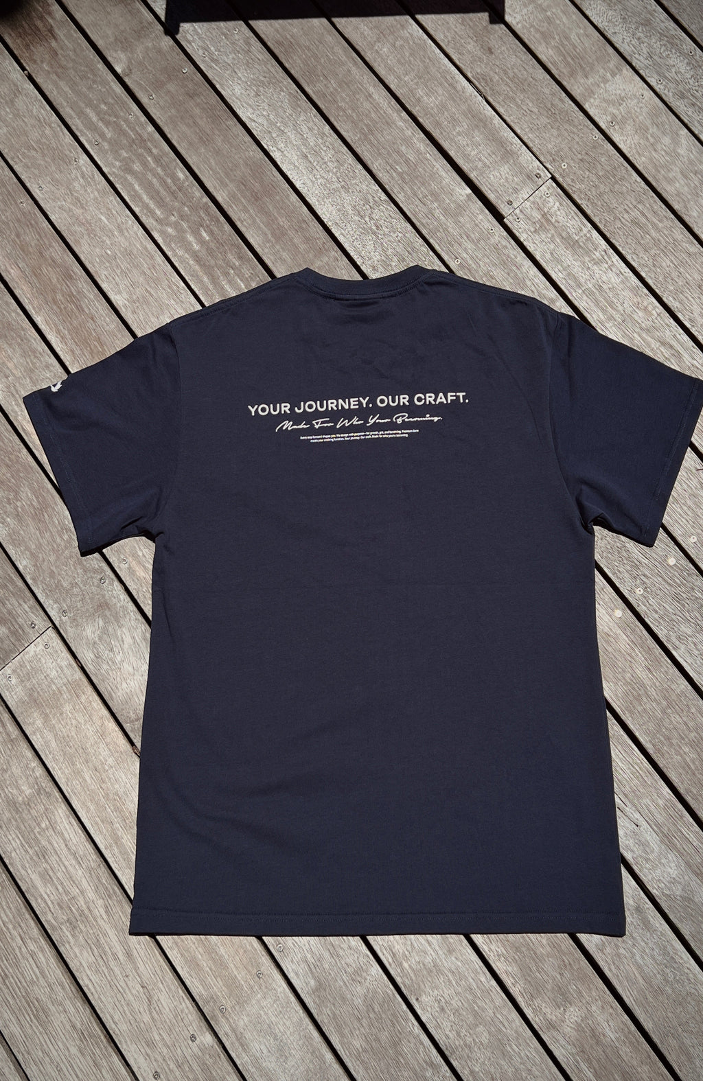 About Us Essential Training T-Shirt — chest logo detail, everyday training tee
