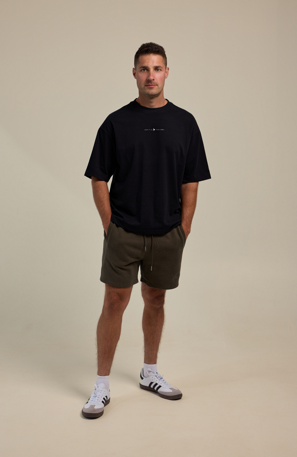 About Us Oversized Logo T-Shirt — chest logo detail, structured drape