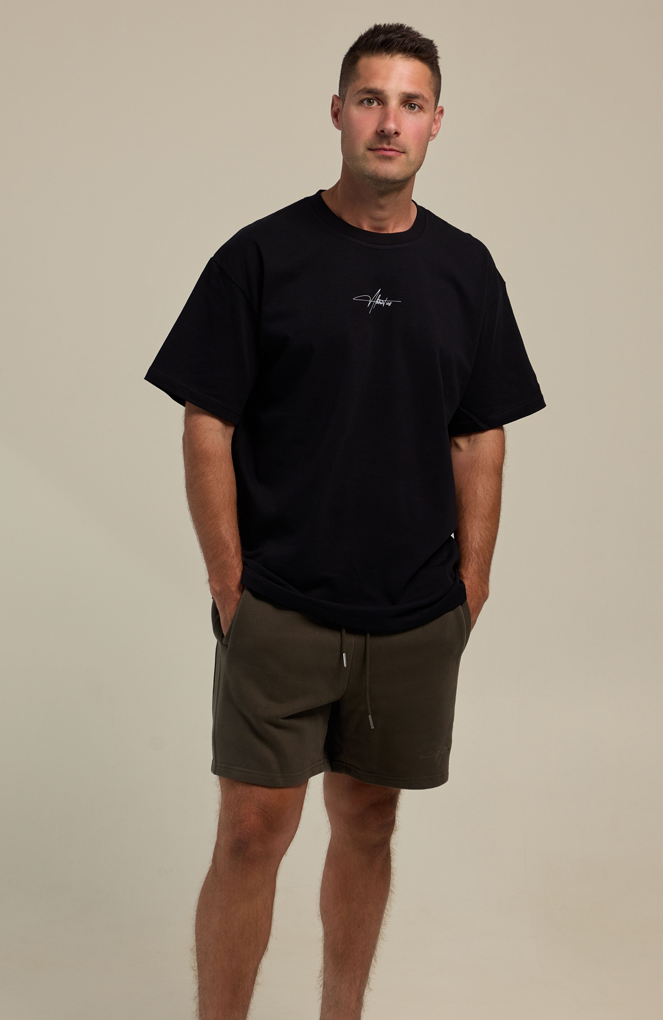 About Us Signature Logo Loose Fit T-Shirt — full length Black colourway