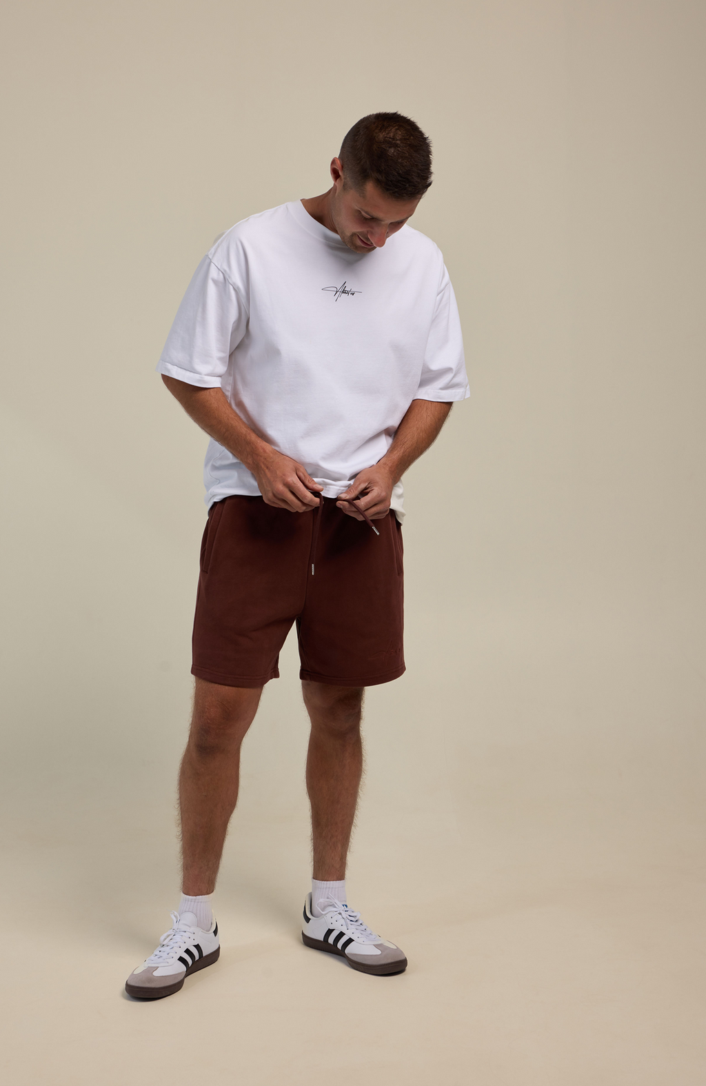 About Us Signature Logo Loose Fit T-Shirt — flat lay, 180gsm cotton