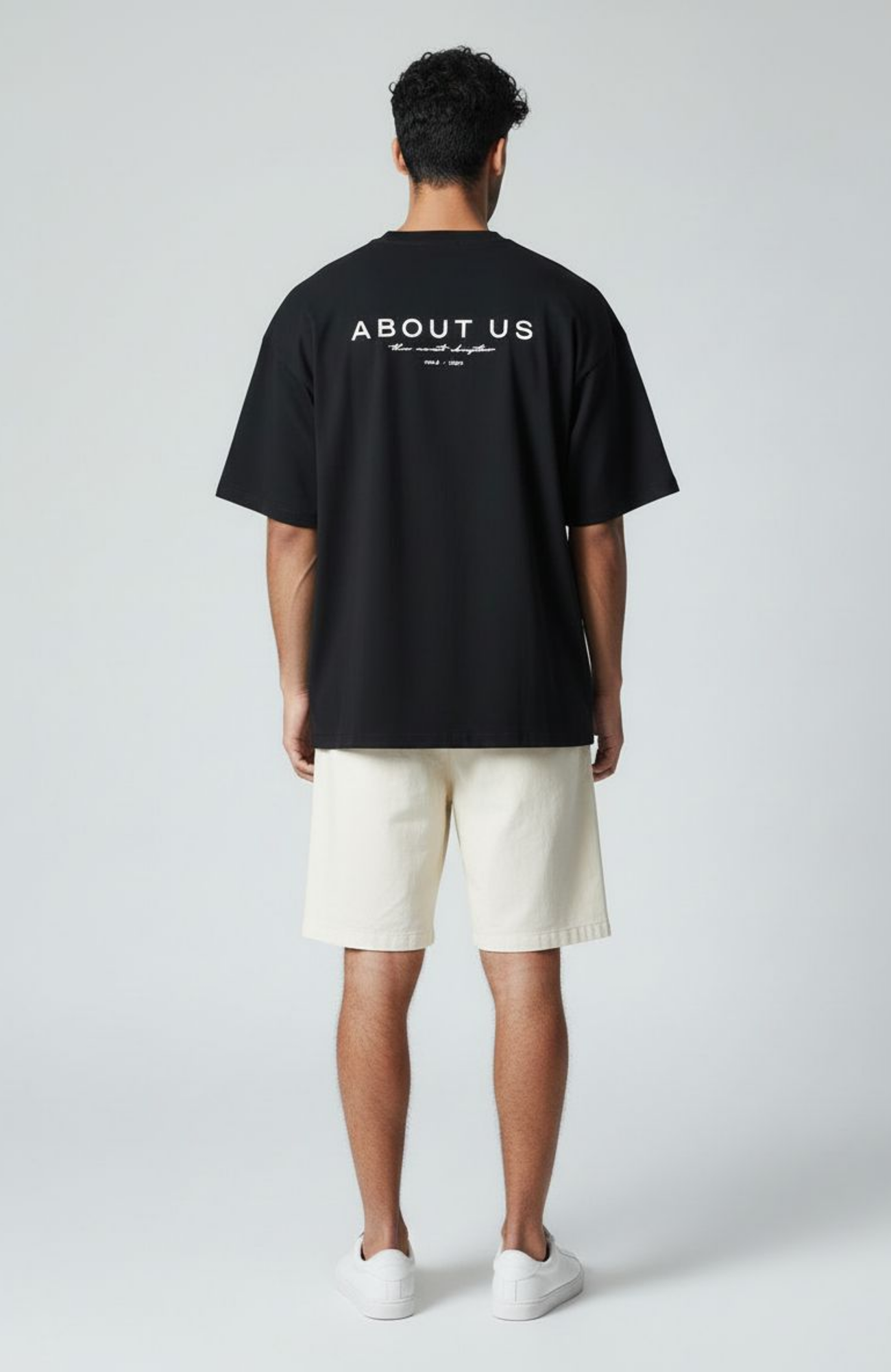 About Us The Next Chapter Oversized T-Shirt — Black colourway, boxed fit