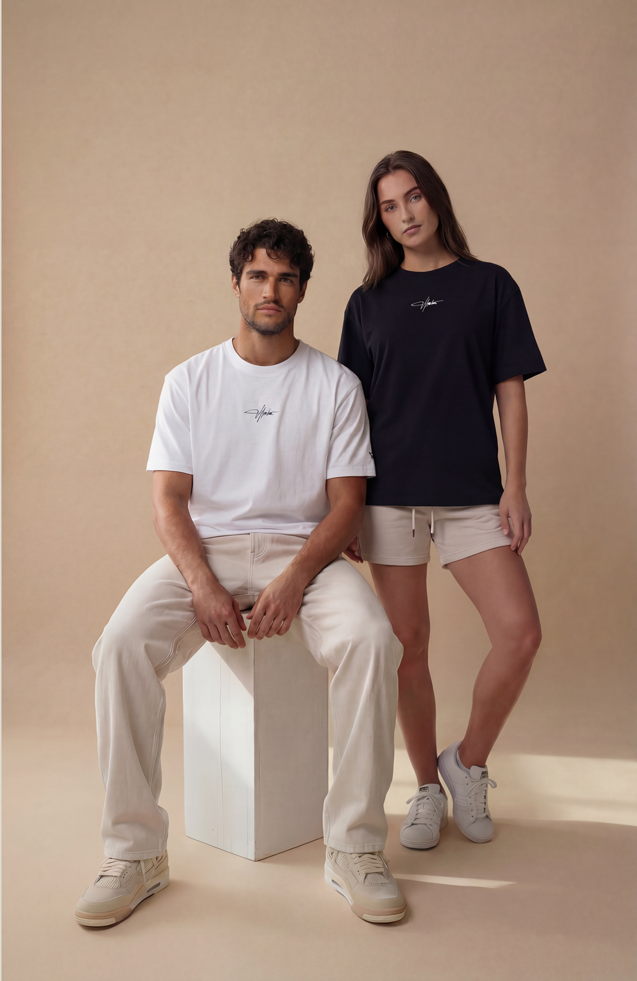 About Us Signature Logo Loose Fit T-Shirt — close-up logo placement