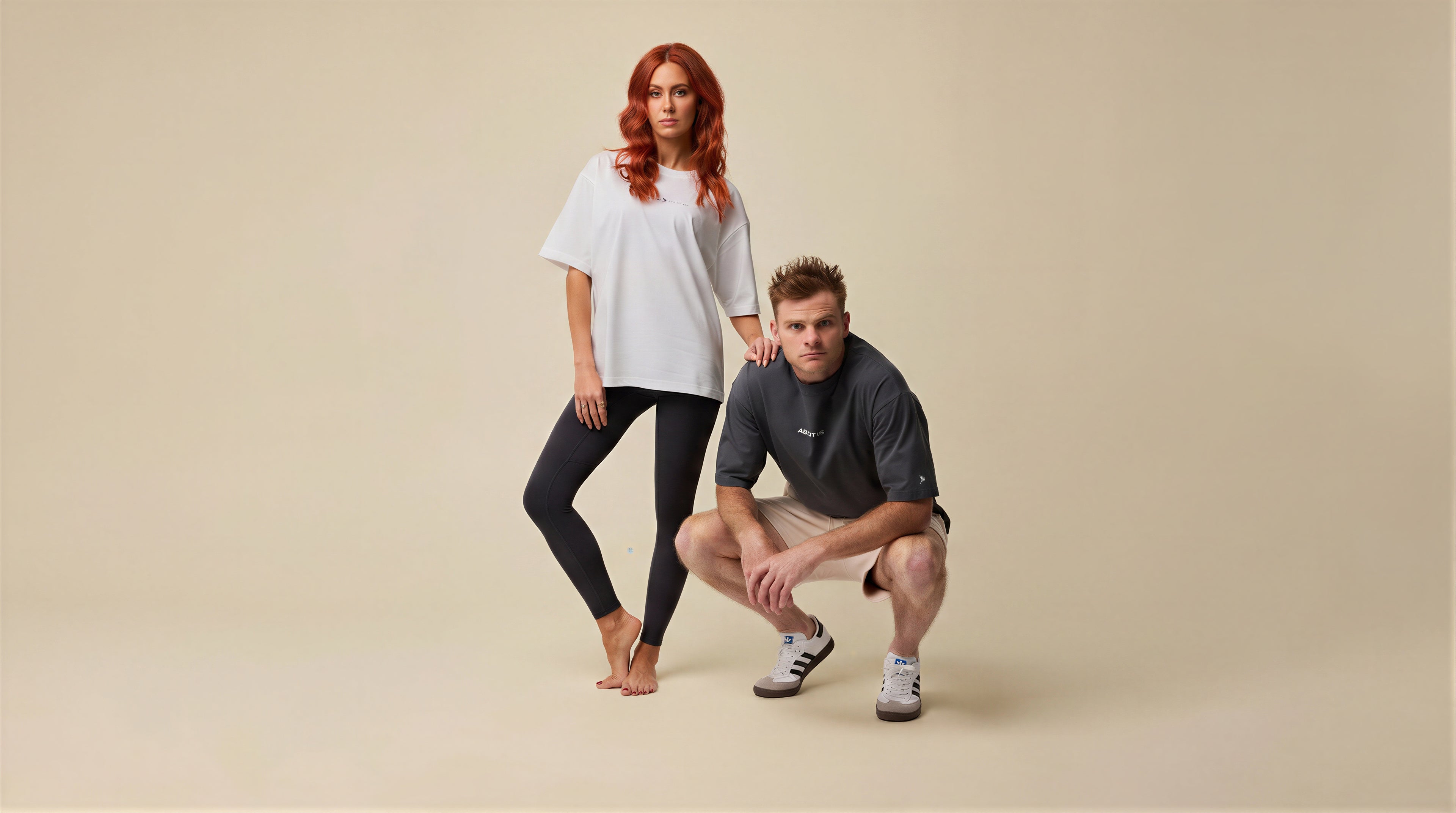 About Us tees — male and female models, studio (hero)