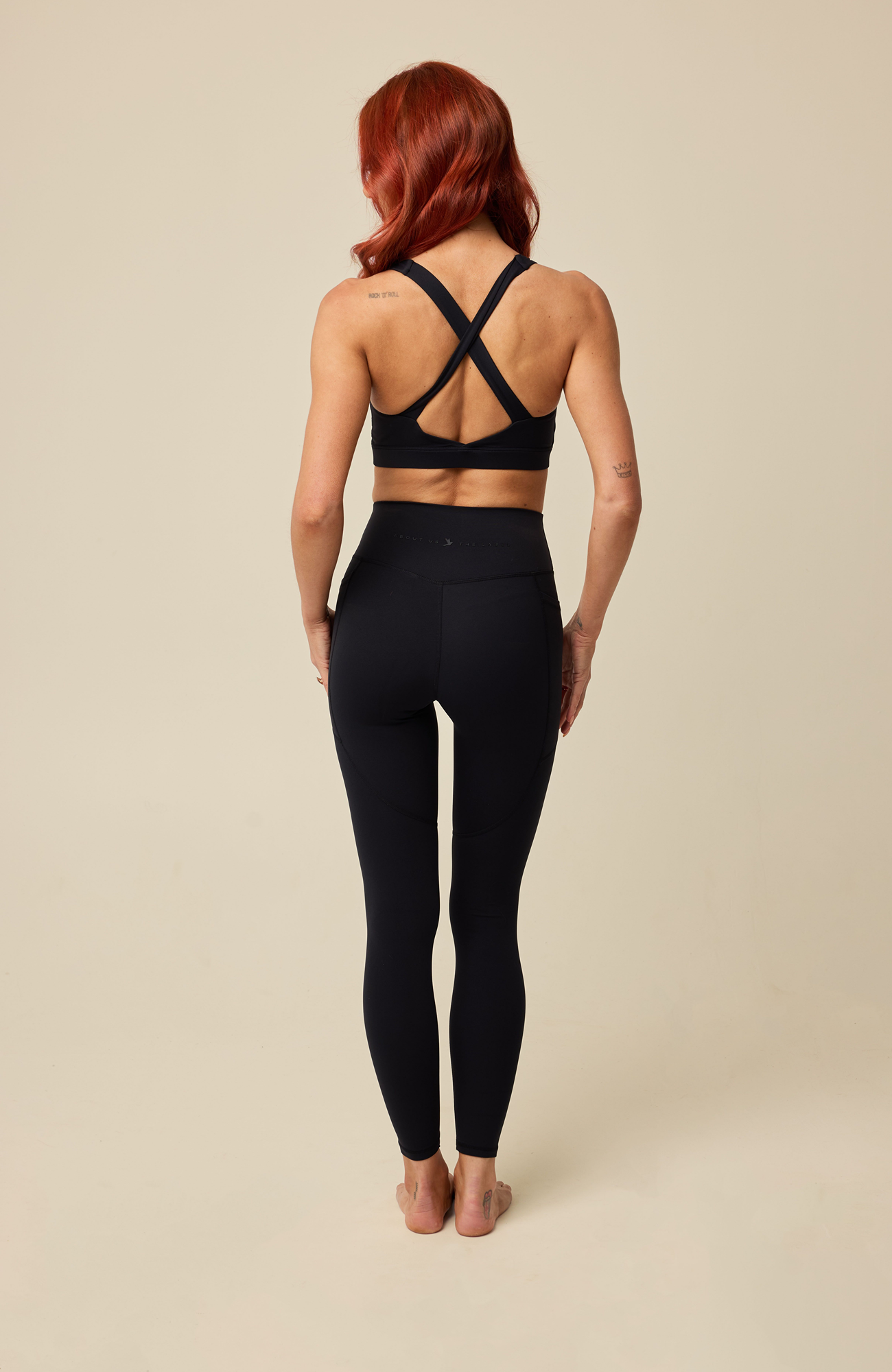 About Us Aura black sports leggings, back view
